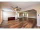 Spacious living room featuring wood floors, large windows, and dual ceiling fans for a comfortable living space at 1849 Wanda Way, Ellenwood, GA 30294