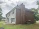 Back exterior of two-story home with a chimney at 1433 Cotton Sw Trl, Conyers, GA 30094