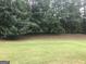 View of the lawn and treeline in the backyard at 1433 Cotton Sw Trl, Conyers, GA 30094