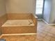 Corner bathtub with tan tile at 1433 Cotton Sw Trl, Conyers, GA 30094
