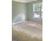 Bedroom featuring light gray walls and a large window at 1433 Cotton Sw Trl, Conyers, GA 30094