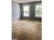 Bedroom featuring light gray walls, neutral carpet and two large windows at 1433 Cotton Sw Trl, Conyers, GA 30094