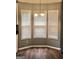 Cozy breakfast nook featuring hardwood floors, natural light from three windows, and modern light fixture at 1433 Cotton Sw Trl, Conyers, GA 30094