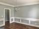 Dining room with hardwood floors, detailed trim, and chandelier at 1433 Cotton Sw Trl, Conyers, GA 30094