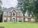 Traditional two-story brick home featuring an arched window and a well-manicured lawn at 1433 Cotton Sw Trl, Conyers, GA 30094