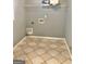 Laundry room with tiled floors and overhead shelving at 1433 Cotton Sw Trl, Conyers, GA 30094