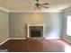 Spacious living room with hardwood floors and stone fireplace at 1433 Cotton Sw Trl, Conyers, GA 30094