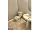Powder room with tiled floors, pedestal sink, and standard toilet at 1433 Cotton Sw Trl, Conyers, GA 30094