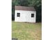 White shed with double doors and two windows at 1433 Cotton Sw Trl, Conyers, GA 30094
