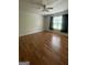 Spacious bedroom with laminate flooring, a ceiling fan, and a large window providing natural light at 14104 Fairington Ridge Cir, Lithonia, GA 30038