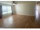 Bright living room with laminate flooring, a ceiling fan, and lots of natural light at 14104 Fairington Ridge Cir, Lithonia, GA 30038