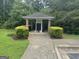Community mailbox area with brick columns and greenery in a landscaped common area at 14104 Fairington Ridge Cir, Lithonia, GA 30038