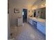 Bright bathroom featuring double sinks, vanity with white cabinets, and a large mirror at 5725 Lake Windsor Pkwy, Buford, GA 30518