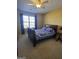 Cozy bedroom featuring a queen-sized bed, window with natural light, and a ceiling fan at 5725 Lake Windsor Pkwy, Buford, GA 30518