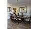 Dining room with a glass table, chandelier, large mirror, and hardwood floors at 5725 Lake Windsor Pkwy, Buford, GA 30518