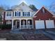 Charming two-story home with brick and siding, well-manicured lawn, and attached two-car garage at 5725 Lake Windsor Pkwy, Buford, GA 30518