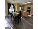 Eat-in kitchen with wooden cabinetry, island, laminate floors, and natural light at 5725 Lake Windsor Pkwy, Buford, GA 30518