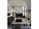 Bright living room featuring a fireplace, large windows, and comfortable seating at 5725 Lake Windsor Pkwy, Buford, GA 30518