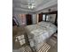 Spacious main bedroom with tray ceiling, ceiling fan, and an ensuite bathroom at 5725 Lake Windsor Pkwy, Buford, GA 30518