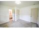 Bright bedroom featuring neutral walls and carpet, plus an attached bathroom at 125 Point View Ct, Tyrone, GA 30290