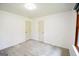 Light filled bedroom with neutral walls and carpet, featuring multiple closets at 125 Point View Ct, Tyrone, GA 30290