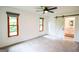 Bright bedroom with multiple windows and a view to bathroom with white vanity and barn door at 125 Point View Ct, Tyrone, GA 30290