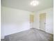This bedroom features neutral walls, gray carpet, and two doors at 125 Point View Ct, Tyrone, GA 30290