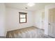 A bright, airy bedroom with neutral walls and gray carpet at 125 Point View Ct, Tyrone, GA 30290