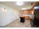 A view of the kitchen, which includes an island, lots of cabinet space, and a black refrigerator at 125 Point View Ct, Tyrone, GA 30290