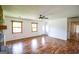 Bright living room with hardwood floors, featuring a stone fireplace and large windows for natural light at 125 Point View Ct, Tyrone, GA 30290