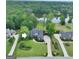 Aerial view of a beautiful home with lush landscaping, a serene pond, and mature trees at 383 Beaumont Farms Dr, Sharpsburg, GA 30277