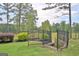 A beautifully landscaped backyard with a black metal fence offers peaceful outdoor living near a lake at 383 Beaumont Farms Dr, Sharpsburg, GA 30277