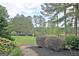 Spacious backyard with mature trees, manicured landscaping, and a tranquil atmosphere at 383 Beaumont Farms Dr, Sharpsburg, GA 30277