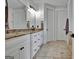 Bright bathroom boasts double vanity with granite counters and stone floors at 383 Beaumont Farms Dr, Sharpsburg, GA 30277