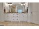 Bright bathroom boasts double vanity with granite counters and stone floors at 383 Beaumont Farms Dr, Sharpsburg, GA 30277