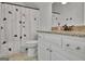 Bathroom with granite countertops, white cabinets, and a shower featuring a decorative curtain at 383 Beaumont Farms Dr, Sharpsburg, GA 30277