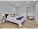 Comfortable bedroom featuring recessed lighting, a queen size bed, and a hardwood floor at 383 Beaumont Farms Dr, Sharpsburg, GA 30277
