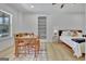 Bright bedroom featuring a light wood floor, built-in shelves, and a decorative rug at 383 Beaumont Farms Dr, Sharpsburg, GA 30277
