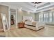 Spacious bedroom with trey ceiling, wood floors, and access to walk-in closet at 383 Beaumont Farms Dr, Sharpsburg, GA 30277