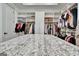 Large walk-in closet with granite island, plenty of shelving, rods for hanging clothes and natural lighting at 383 Beaumont Farms Dr, Sharpsburg, GA 30277