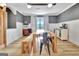 Bright dining room featuring natural light, wood table, light wood floors, and decorative accents at 383 Beaumont Farms Dr, Sharpsburg, GA 30277