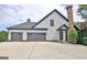 Exterior side angle view of a two-story home with three garage doors and a well-kept lawn at 383 Beaumont Farms Dr, Sharpsburg, GA 30277