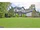 Charming two-story home with manicured lawn, black trim and stone accents at 383 Beaumont Farms Dr, Sharpsburg, GA 30277