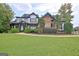 Stunning two-story home with a manicured lawn, stone and siding details, and a welcoming front porch at 383 Beaumont Farms Dr, Sharpsburg, GA 30277