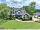 Aerial view of a beautiful home with a dark roof and pristine lawn at 383 Beaumont Farms Dr, Sharpsburg, GA 30277