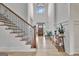 Grand two-story foyer with hardwood floors, staircase, and elegant decor provides a welcoming entry at 383 Beaumont Farms Dr, Sharpsburg, GA 30277