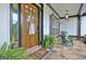 Inviting front door with stone porch, rocking chairs, and charming welcome decor at 383 Beaumont Farms Dr, Sharpsburg, GA 30277