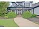 Elegant home exterior with black and white accents, covered porch, and manicured landscaping at 383 Beaumont Farms Dr, Sharpsburg, GA 30277