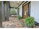 Inviting front porch with stone flooring, wooden pillars, swing, and fern accents at 383 Beaumont Farms Dr, Sharpsburg, GA 30277