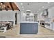 This spacious kitchen boasts an island with white marble countertop, stainless steel appliances, and custom pendant lighting at 383 Beaumont Farms Dr, Sharpsburg, GA 30277